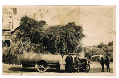 Four men with a vintage bus.