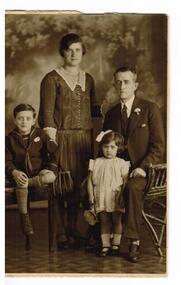 A family photograph with the parents and their son and daughter.