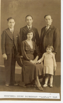 A family photograph with the parents, two young men and a little girl.