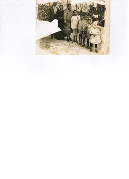 A family group of three adults and five children.