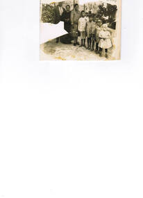 A family group of three adults and five children.