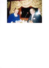 A couple seated in a restaurant car.