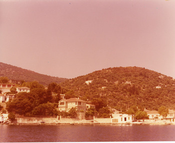 A port-side village with mountains in the background.