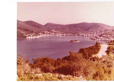 A panoramic view of a harbour with a small island.