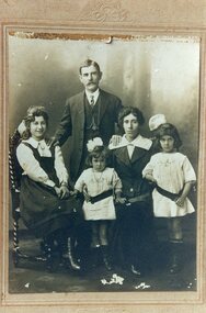 A family group of the parents with their three girls.
