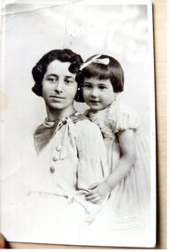 A studio photograph of a lady and little girl.