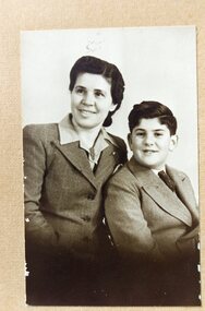 A studio photograph of a mother and son