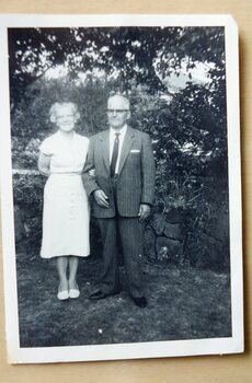 A lady and man standing in a garden.