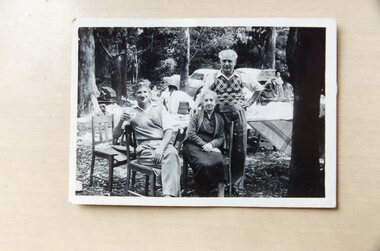 Two men and a lady at a picnic.