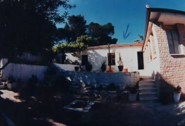 A shadow is across the yard in the photograph.