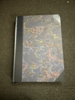 Illustrated hardcover book with dark blue/grey/red/gold marble effect front and back cover. Black leather corners and spine. Title and author's name are embossed in gold on a red background on spine. Also on spine are 13 gold bands and 5 gold decorations. The book has a matching cardboard sleeve.