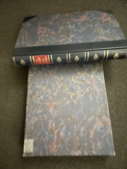 Spine photo of Book with book title in gold print.