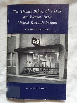Paperback book blue front cover with full title, author and black and white photo of entrance to Baker institute (1974). Describes the History of the first fifty years of the Baker Institute and includes numerous black and white photos of people within. 