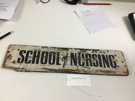 Wooden sign inscribed with School of Nursing