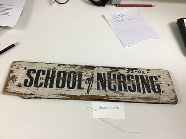 Wooden sign inscribed with School of Nursing