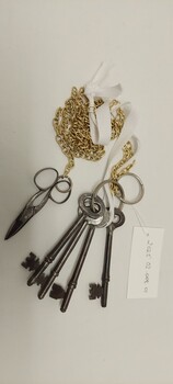Key chain [reproduction] with small metal scissors and 4 keys that hang from the belt of the nurses uniform.