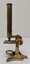 Brass and glass microscope made of 3 parts consisting of a Brass body, eye piece and eye piece adaptor. 