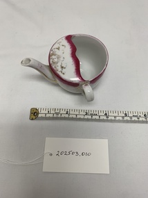 Functional object - spouted china feeding cup with handle, small pink and white patterned, gold painted detail