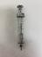 A glass syringe with graduation markings down the side, and a metal end for depressing the plunger and opposite end to attach needles.