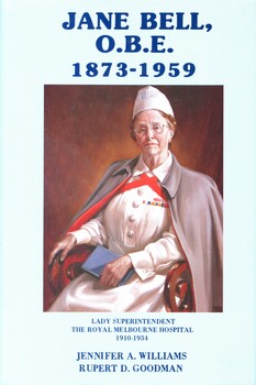 Illustrated book with dustjacket with cerulean blue cover, with the emblem of the Royal Melbourne Hospital nurse training school embossed in gilt on the front.  The dust jacket has a pale blue background, with title and authors names printed in dark blue ink on the front and spine. Also on the front cover is a coloured illustration of a nurse in uniform, wearing a cap and cape (portrait of Jane Bell O.B.E by Vernon Jones, 1948). This book explores the life and contributions of Jane Bell, who served as the Lady Superintendent at the Royal Melbourne Hospital. 