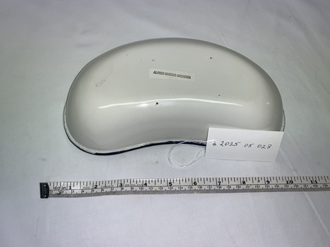 white enamel kidney dish, blue rim, some minimal damage to base, white rectangular sticker central to base black ink stamp ALFRED NURSES ARCHIVE