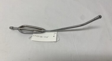 2 piece metal curved tube, with detachable screw on tip. Screw on tip has one hole at the tip and 4 holes equally spaced around the tip. Handle end has 2 rounded pieces of metal additions that form the hand grip. Used to suction oropharyngeal secretions. 