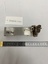 silver metal holder with bracket to attach to bed frame. original catalogue number 176-98 in black marker, also blue pen on white sticker