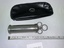 silver metal cylindrical barrel syringe and plunger, black vinyl case with zip closure