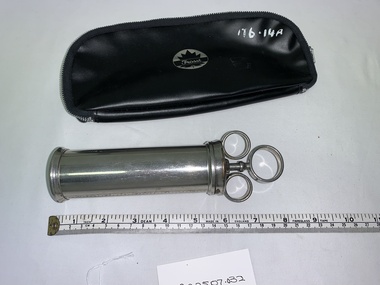 silver metal cylindrical barrel syringe and plunger, black vinyl case with zip closure