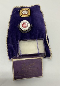 A purple velvet pouch with gold trim holds two vintage pins and an empty purple jewellery box labeled Dumbrells The Jewellers, 319-321 Bourke St, Melbourne, directly opposite Myers. Phone Central 7580.