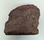 side view of broken dark red brick