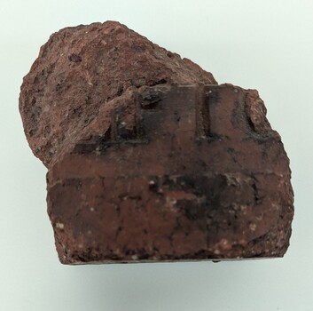 Top view of broken dark red brick
