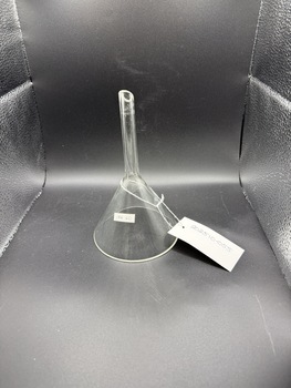Clear glass funnel, sitting upside-down on its rim, the tip is cut at an angle.  The glass is 2mm thick and the edges raw but not sharp.