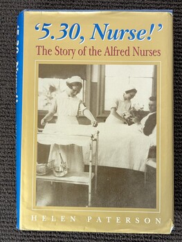 Front of dustjacket of '5.30 nurse! :the story of the Alfred nurses', Helen Paterson, 1996. Two nurses in uniform, the one on the left is setting a trolley