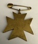 A gold star-shaped medal with a safety pin attachment, embossed with "STOKES & SONS" on the back.