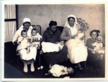 Group of nurses with youg girl and infants [ca.1920]