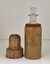 wooden container, with lid beside it, containing a glass bottle 