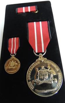 Boxed set of Australian Defence Medals, large and small medal with red and white ribbons.