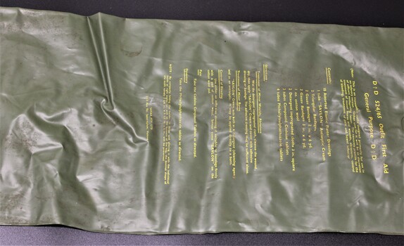 A first aid kit housed in a long khaki green plastic roll that was in general use during the Vietnam War. 