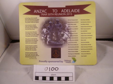 A Mouse pad with three columns of texts; image of two soldiers culpture in the middle and a crimson ribbon