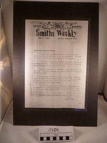 A laminated paper on black paper about a commanding officer message on Smiths Weekly. 