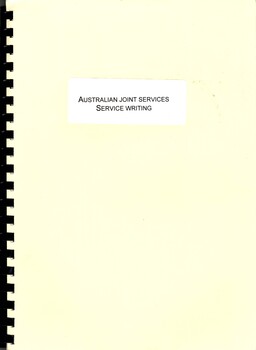 A manual with a cream coloured cover with "Australian Joint Services Service Writing on a white label that is on the cover