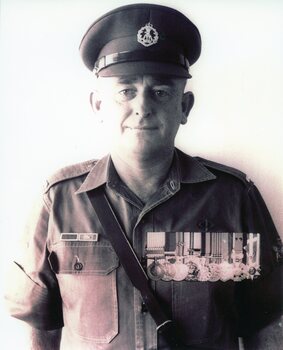 
Sepia photo of David Norman Ogg, RAAF Aircraftman, in uniform with cap and medals, post-Vietnam