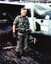 A colour photograph of David Norman Ogg in flying suit with helmet, beside aircraft in Vietnam