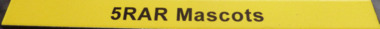 A yellow board with black texts "5RAR Mascots"