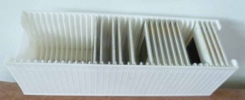 White plastic ribbed tray able to hold thirty-six 35mm slides.