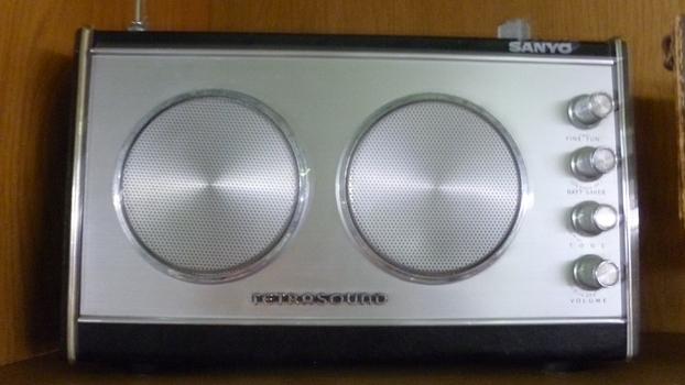 Sanyo Silver and black twin speaker transistor radio with silver handle.