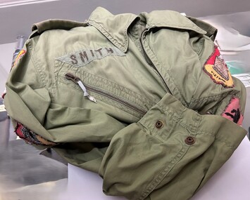 Khaki green 'Flying Suit' with the name Smith on the pocket