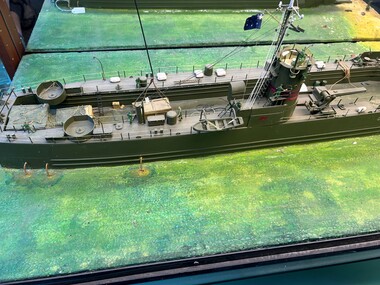 Diorama of a landing craft ashore with a sky crane above