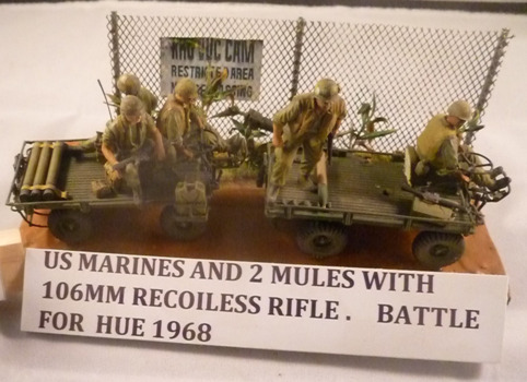 A diorama of US Marines with two mules